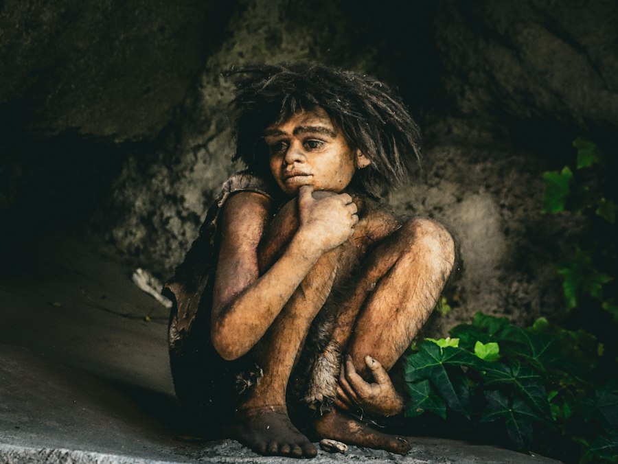 Photo prehistoric boy hiding food for sick companion